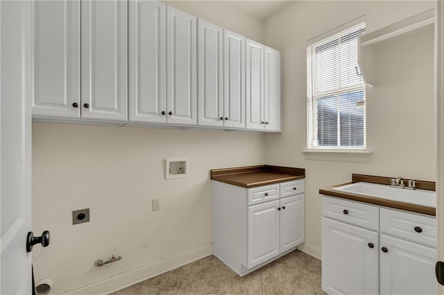 laundry room featuring hookup for a washing machine, cabinet space, hookup for an electric dryer, a sink, and gas dryer hookup