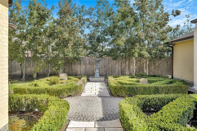 view of property's community featuring fence and a patio