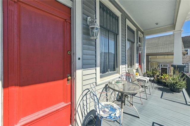 view of exterior entry featuring covered porch