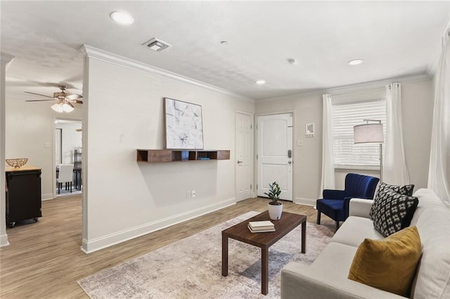 living room with recessed lighting, visible vents, baseboards, ornamental molding, and light wood finished floors