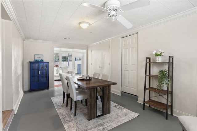 dining area with baseboards, concrete floors, and ornamental molding