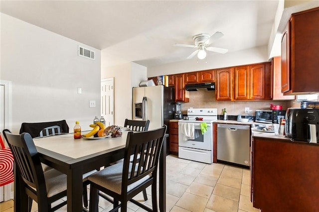 kitchen featuring visible vents, appliances with stainless steel finishes, light tile patterned flooring, ceiling fan, and under cabinet range hood