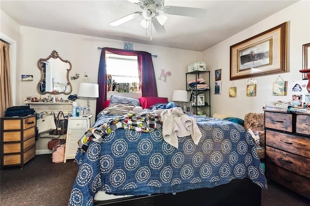 bedroom with ceiling fan and dark carpet