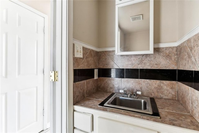 kitchen featuring visible vents and a sink