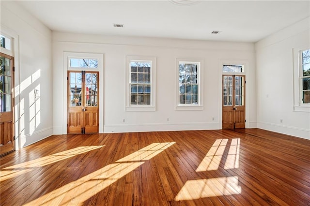 3829 Dauphine St, New Orleans, LA 70117 - interior space with baseboards, visible vents, and wood finished floors