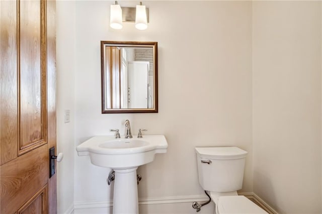 3829 Dauphine St, New Orleans, LA 70117 - half bathroom with baseboards and toilet