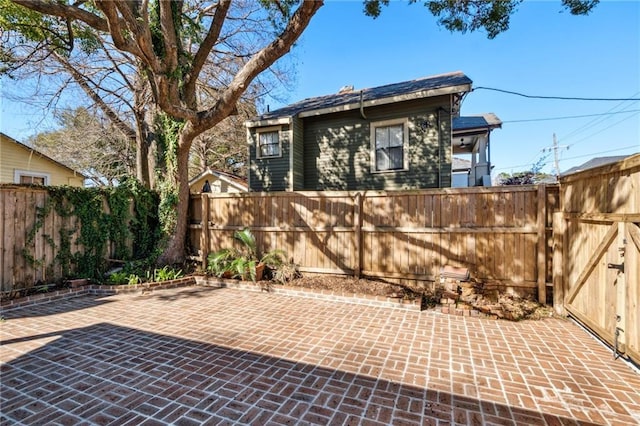 view of patio featuring a fenced backyard and a gate