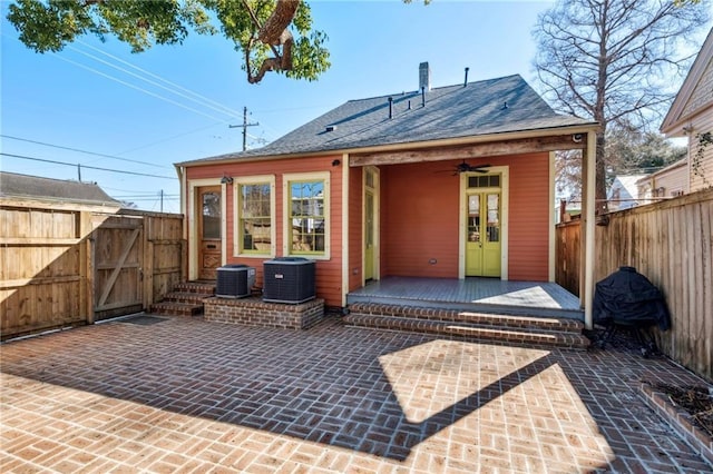 3829 Dauphine St, New Orleans, LA 70117 - back of property featuring ceiling fan, central air condition unit, fence, a gate, and a patio area