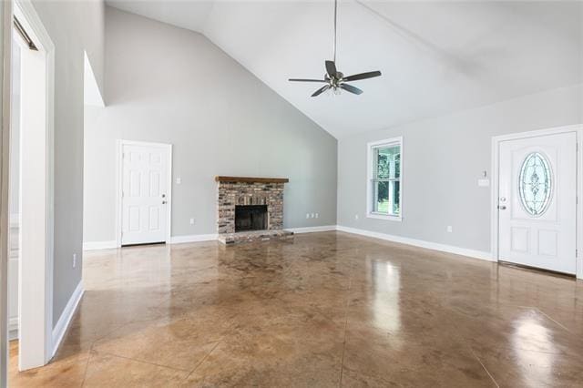 unfurnished living room featuring baseboards, high vaulted ceiling, a brick fireplace, and ceiling fan
