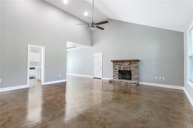 unfurnished living room featuring baseboards, ceiling fan, a fireplace, and finished concrete flooring