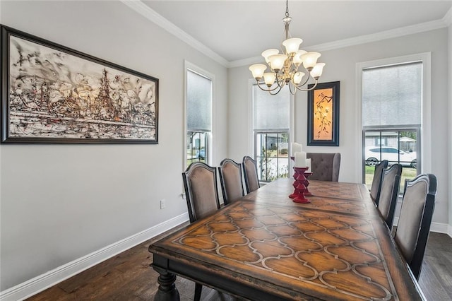 dining room with ornamental molding, dark wood-type flooring, an inviting chandelier, and baseboards