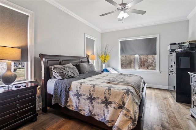 bedroom with dark wood-style floors, ceiling fan, baseboards, and crown molding