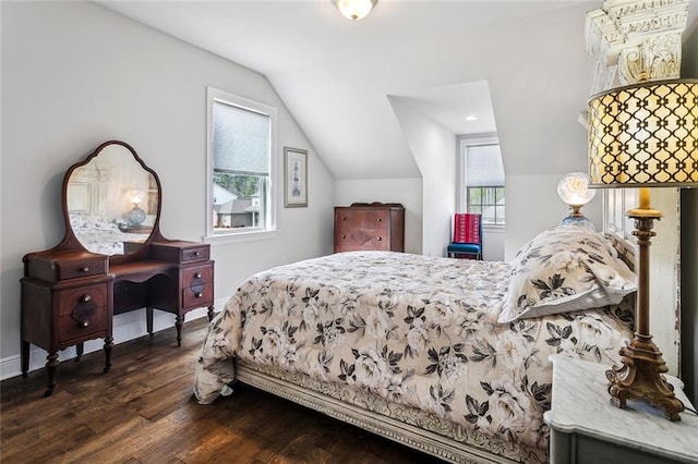 bedroom with vaulted ceiling, dark wood-style flooring, and baseboards