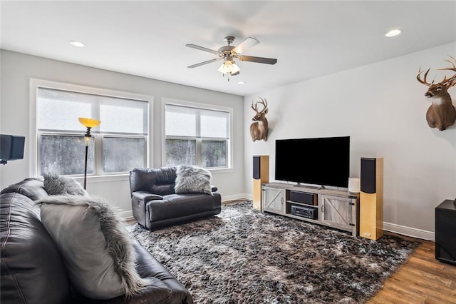 living room featuring a ceiling fan, baseboards, wood finished floors, and recessed lighting