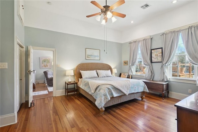 bedroom featuring recessed lighting, wood finished floors, a ceiling fan, visible vents, and baseboards