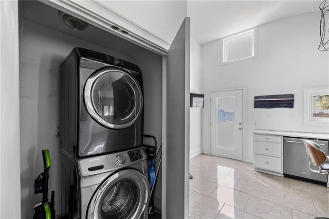 clothes washing area with laundry area and stacked washer / drying machine