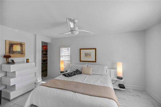 bedroom with marble finish floor, baseboards, and a ceiling fan