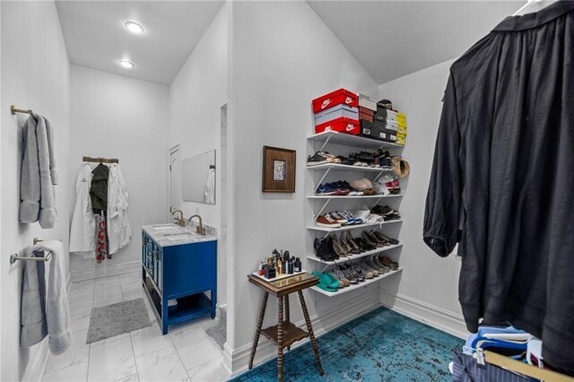 spacious closet featuring marble finish floor