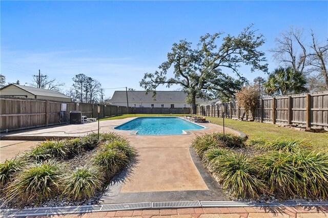 view of swimming pool featuring a yard, a fenced backyard, a fenced in pool, and a patio