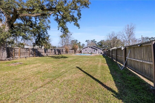 view of yard featuring a fenced backyard and a fenced in pool