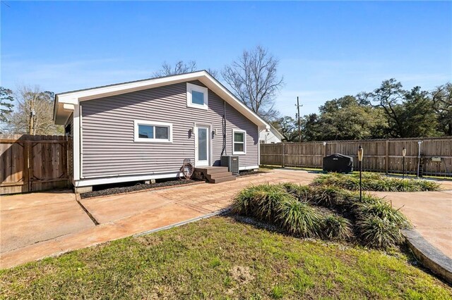 rear view of property featuring a patio and fence private yard