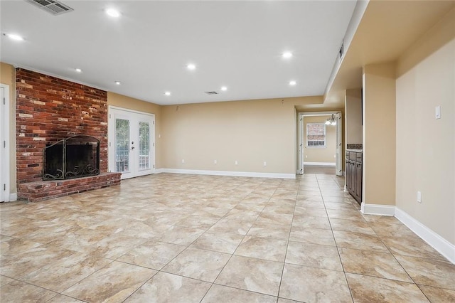 unfurnished living room featuring visible vents, recessed lighting, french doors, light tile patterned flooring, and a fireplace