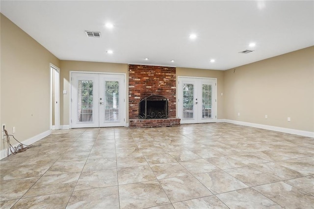 unfurnished living room with visible vents, plenty of natural light, and french doors