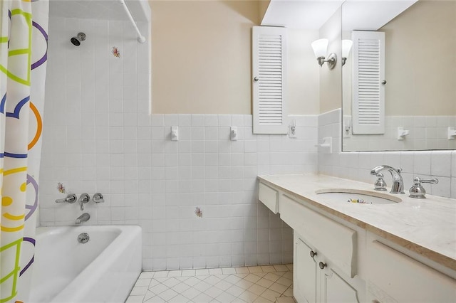 bathroom with vanity, a wainscoted wall, shower / bath combo, tile walls, and tile patterned floors