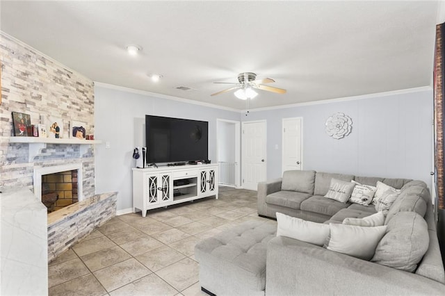 living room featuring light tile patterned floors, a stone fireplace, visible vents, a ceiling fan, and crown molding