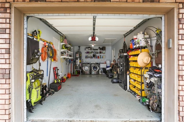 garage with a garage door opener, gas water heater, and separate washer and dryer