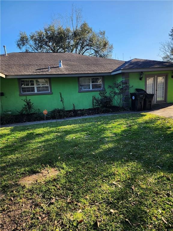 view of property exterior with a yard and stucco siding