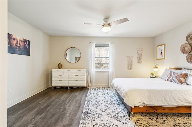 bedroom with dark wood-style floors, ceiling fan, and baseboards