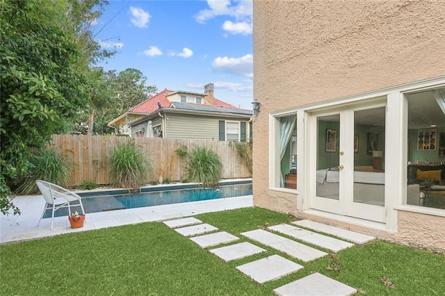 view of yard with fence, a fenced in pool, and a patio