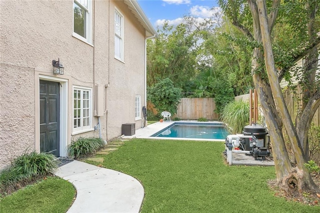 view of pool with a fenced in pool, a fenced backyard, and a lawn