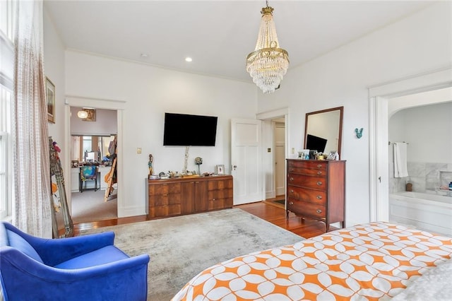 bedroom with wood finished floors, ensuite bathroom, crown molding, a notable chandelier, and recessed lighting