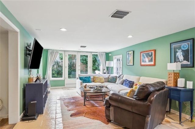 living area with light tile patterned floors, visible vents, french doors, and recessed lighting