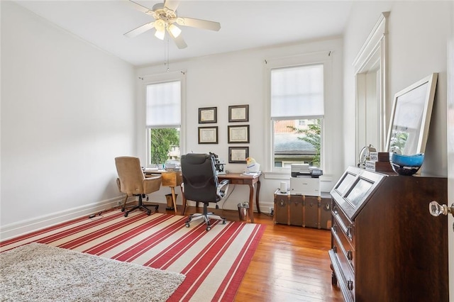 office featuring a ceiling fan, baseboards, and wood finished floors