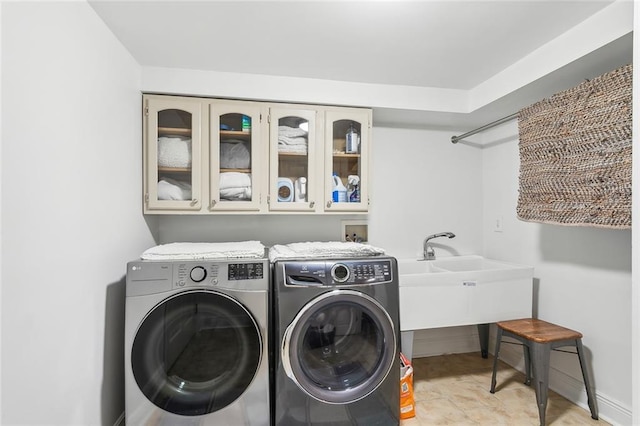 washroom with cabinet space and separate washer and dryer