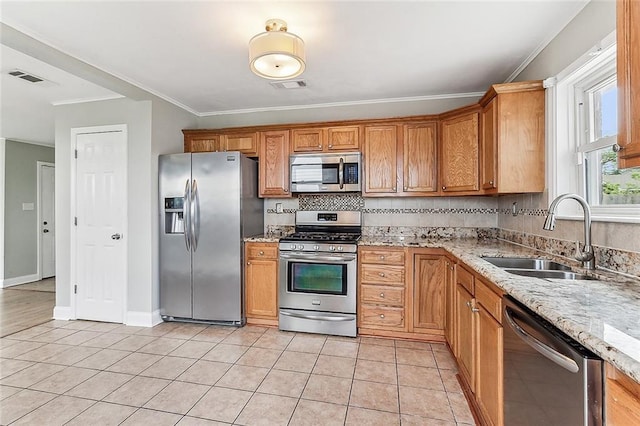 kitchen featuring visible vents, backsplash, appliances with stainless steel finishes, light tile patterned flooring, and a sink