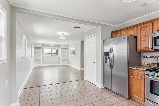 kitchen with stainless steel appliances, brown cabinets, visible vents, and light tile patterned floors