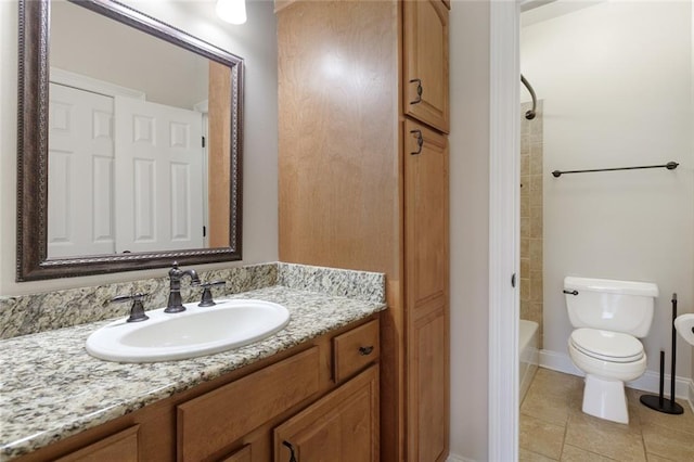 bathroom featuring toilet, tile patterned floors, shower / washtub combination, and vanity