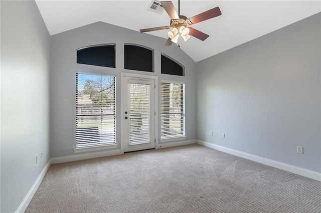 empty room with light carpet, a ceiling fan, visible vents, and baseboards