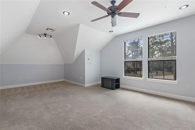 bonus room with light carpet, baseboards, visible vents, a ceiling fan, and lofted ceiling