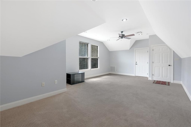 bonus room with lofted ceiling, visible vents, carpet flooring, ceiling fan, and baseboards