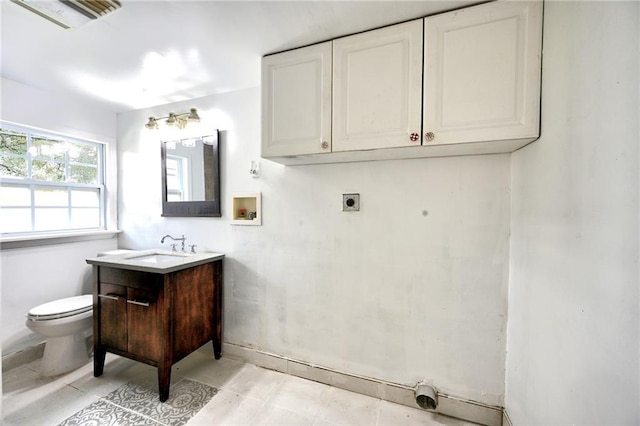 interior space with toilet, tile patterned flooring, and vanity