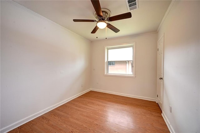 empty room featuring visible vents, light wood-style flooring, and baseboards