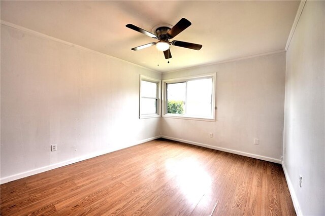 unfurnished room with light wood-style floors, crown molding, baseboards, and ceiling fan