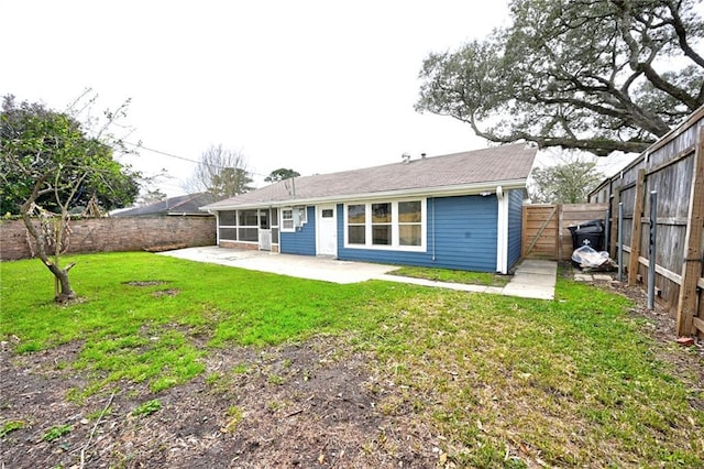 back of house with a patio area, a lawn, and a fenced backyard