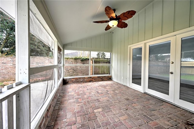 unfurnished sunroom featuring vaulted ceiling and a ceiling fan