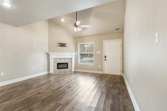 unfurnished living room featuring baseboards, a ceiling fan, dark wood-style flooring, and a tiled fireplace